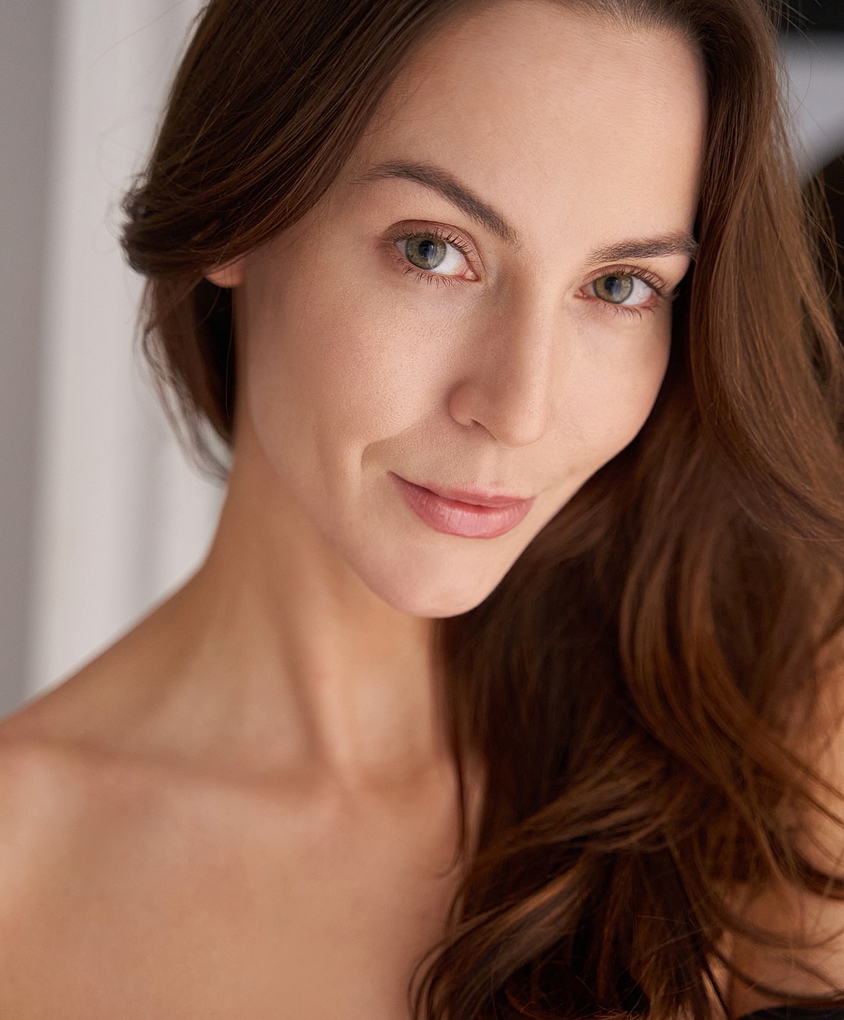 Portrait of a woman with wavy brown hair.