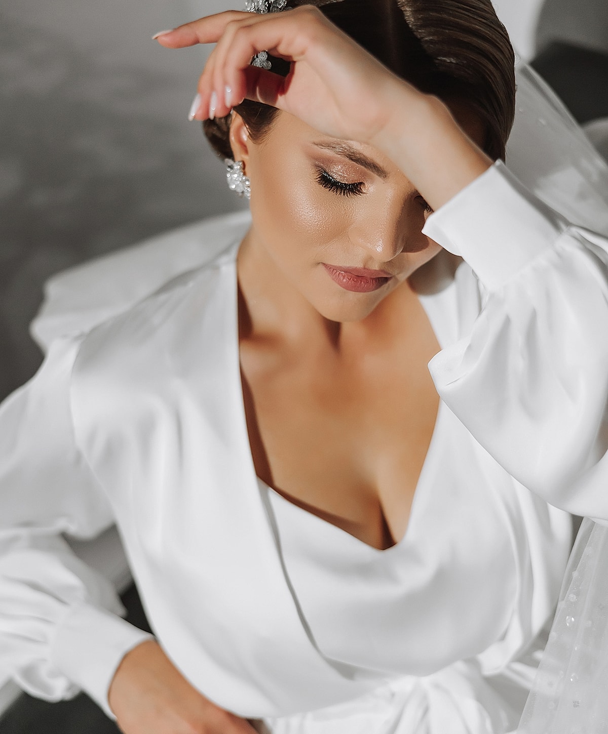 Bridal portrait with elegant white attire and veil.