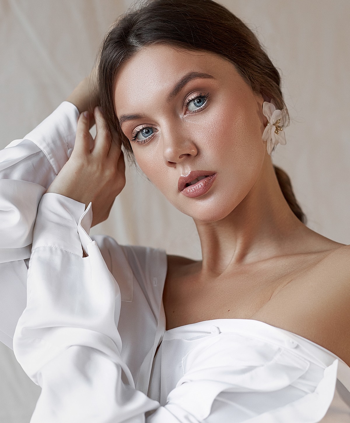 Beautiful woman with flower in elegant white blouse.