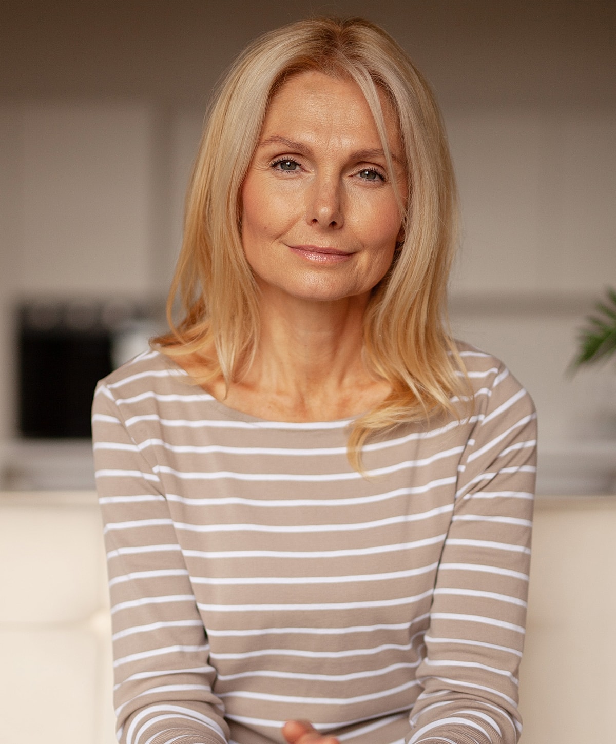 Woman with blonde hair in a striped shirt.