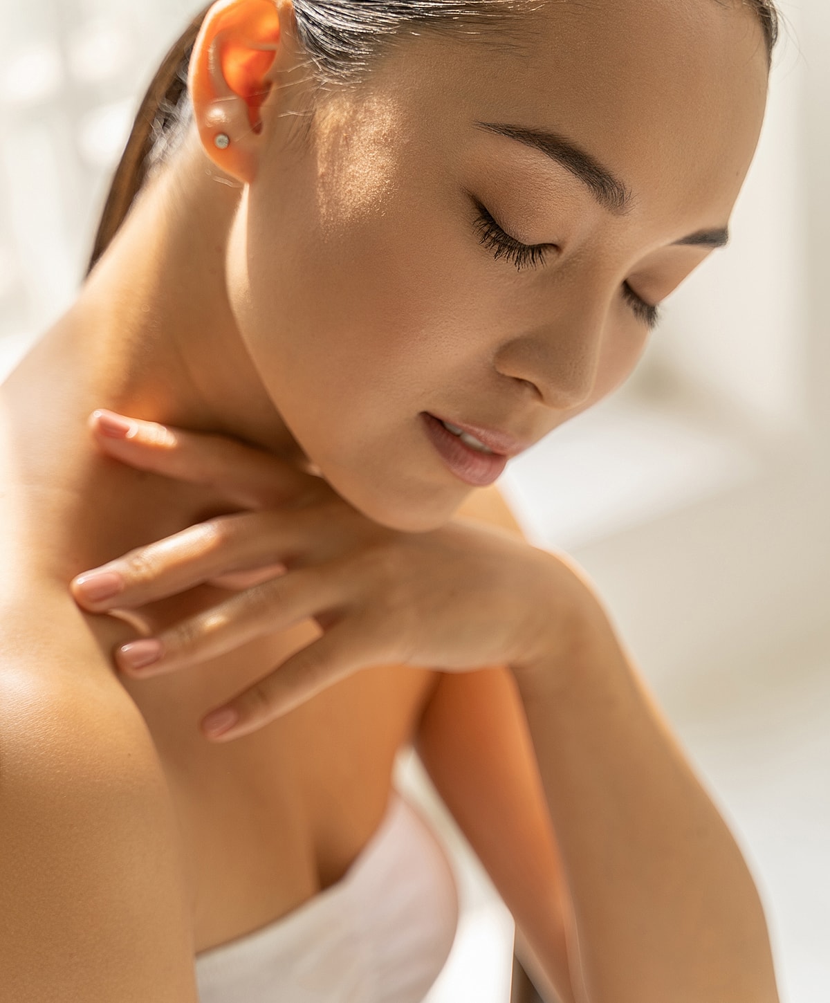 Woman with closed eyes in soft lighting